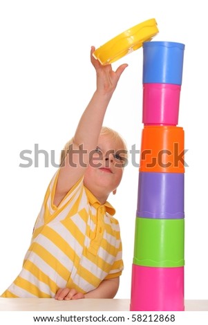Young boy has build a funny stacking tower