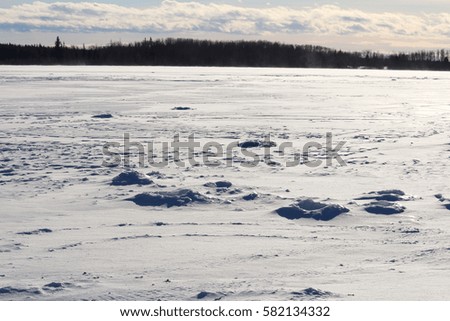 Old Ice Fishing Holes on a Windy Lake