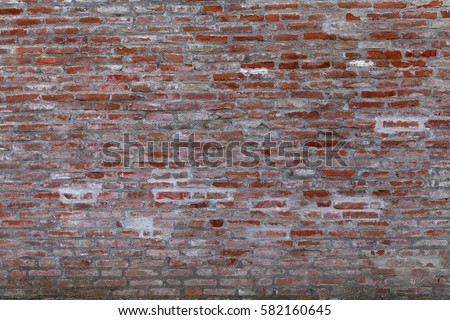Old brick wall texture. Masonry background. Masonry texture. Brickwork with old bricks, deciduous plaster and pieces of mortar. Variegated run-down wall. Squalid bricken face. Shabby bricking sheet