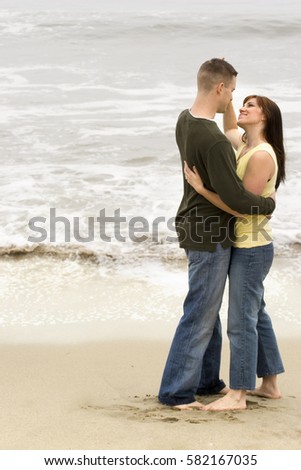Beautiful couple share romantic moments on the beach.