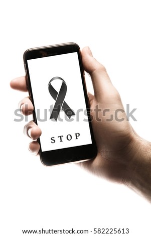 Hand holding smartphone, blank screen with black ribbon isolated on white background. World Cancer Day graphic. Melanoma concept