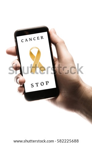 Hand holding smartphone, blank screen with gold ribbon isolated on white background. World Cancer Day graphic. Childhood cancer concept