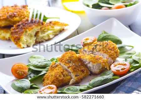 Food fried breading chicken spinach salad tomatoes pancakes from potatoes