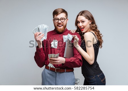 Cunning Woman stick to Male nerd with money. Isolated gray background