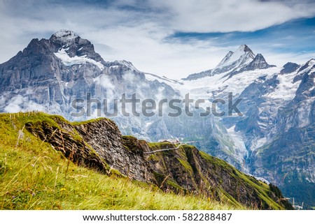 Great view of alpine snowy hills. Picturesque and gorgeous scene. Popular tourist attraction. Location place Swiss alps, Grindelwald valley, Bernese Oberland, Europe. Discover the world of beauty.