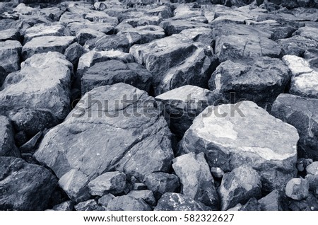 Big black and white stones as a part of the Persian Gulf coastline, background
 Royalty-Free Stock Photo #582322627