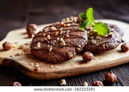 Delicious chocolate cookies with hazelnuts and topping Royalty-Free Stock Photo #582323281