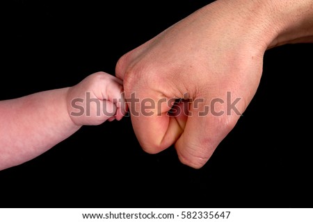 baby touching dad Royalty-Free Stock Photo #582335647