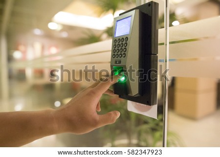 Yong man push down the electronic control machine to access the door Royalty-Free Stock Photo #582347923