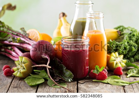 Variety of fresh vegetable and fruit juices in bottles and mason jar. Royalty-Free Stock Photo #582348085