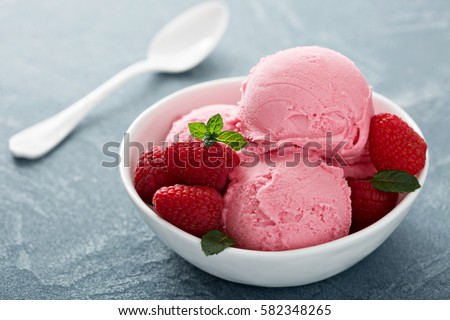 Raspberry ice cream in white bowl close  up