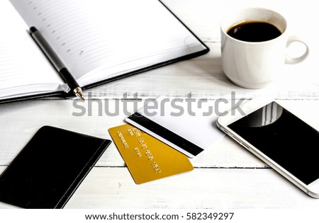 credit card, keyboard, smartphone and coffee cup on wooden backg
