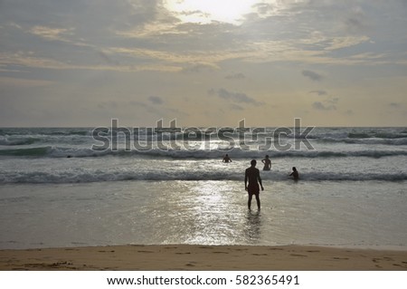 Family in Silhouette of beach with gold light sunsets sky, Karon beach, Phuket, Southern of Thailand, 
