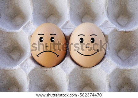 Brown eggs with face expression of sad and happy 