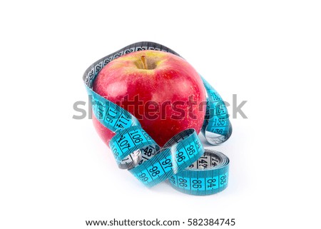 Red ripe fresh apple and measuring tape as part of a useful relationship to health