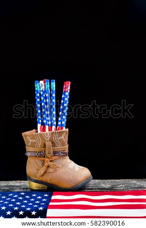  Baby cowboy boots and American flag pencils with room for your type.