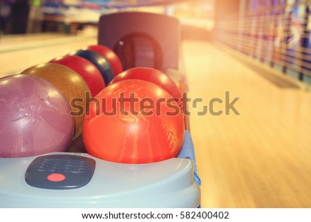 Bowling Balls on the background of the tracks in the bowling club. Play bowling and relax.