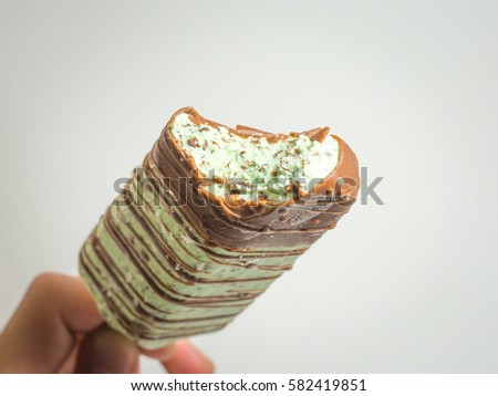 this blue mint milk ice cream stick covered with chocolate