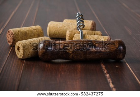 corkscrew for open wine cork on wooden background