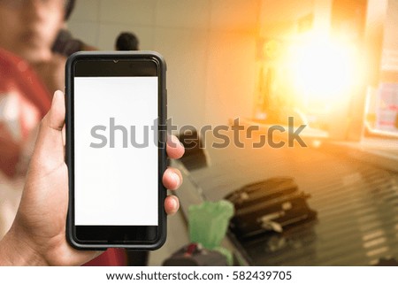 man hand holding smartphone at airport
