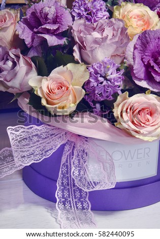 a beautiful bouquet of flowers in a wooden box on a background of a wooden background