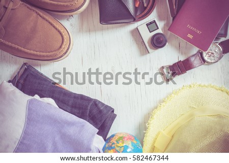Outfit of traveler on green background with copy space, Travel concept,Travel accessories for trip,Travel accessories costumes. Passports, luggage, The cost of travel maps prepared for the trip