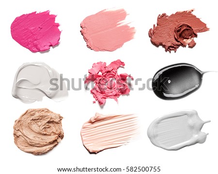 Smears of different colors are made with various cosmetic products isolated on a white background. Texture of multi-colored strokes of various make-up cosmetics on a white background