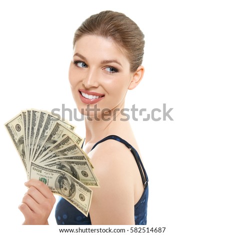 Young happy woman holding cash money dollars happy smiling and looking at copyspace in top left corner of picture, isolated on white background.