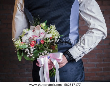a bouquet of flowers from a male businessman