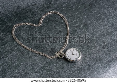A classic and antique pocket watch isolated over black textured background