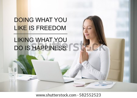 Fit business woman doing online yoga or pilates exercise in office. Fitness motivation quote with motivational text "Doing what you like is freedom, liking what you do is happiness". Healthy concept 