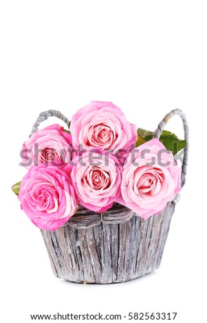 Bouquet of pink roses in basket isolated on a white