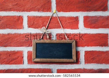 Wooden frame on a brick wall background