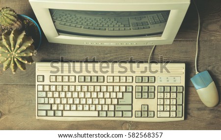 Vintage computer on a wooden table. Top view
 Royalty-Free Stock Photo #582568357
