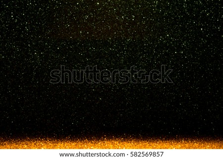 Abstract background filled with shiny gold and green glitter