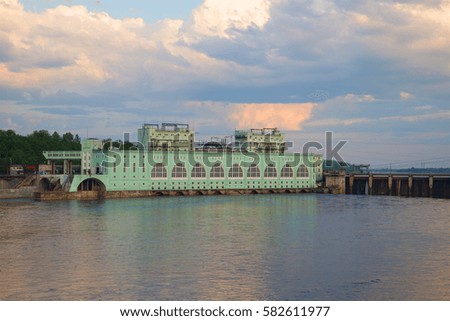 View of the Volkhov hydroelectric station June cloudy in the evening. Volkhov, Russia Royalty-Free Stock Photo #582611977