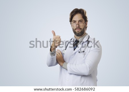 Male doctor on a gray background making a sign that everything is okay