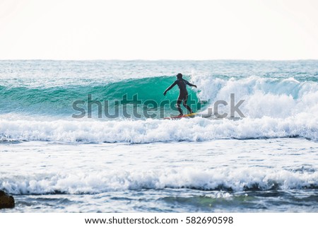 Surfer on wave in ocean. Surfing in california