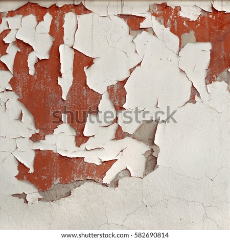 Old cracked wall with peeling paint and plaster