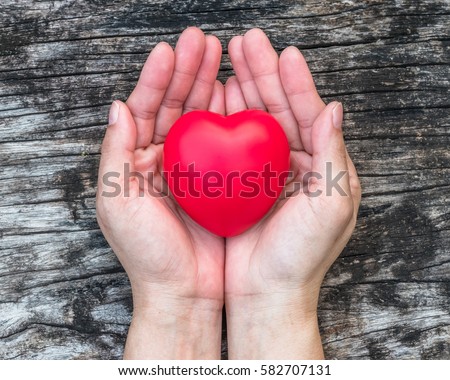 Red love heart on woman's hand support on aging old wood for promoting for health care campaign concept Royalty-Free Stock Photo #582707131