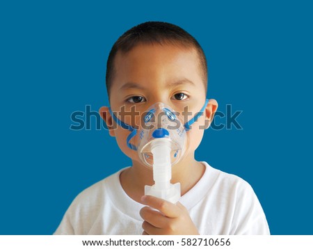 Asian child holding oxygen mark isolated on blue background