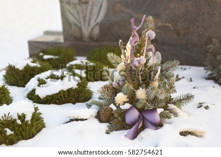 Flower arrangement at a grave in wintertime