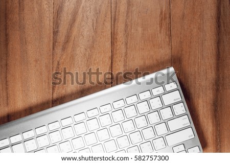 Picture of a keyboard on wood table at business office