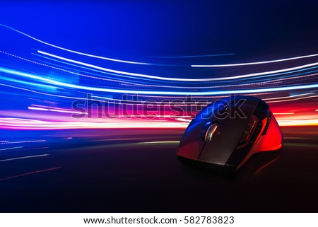 High technology computer gaming mouse fast moving  in blue tone with stroke of lightning as background 