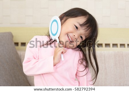 Cute little Asian girl with a Yes sign