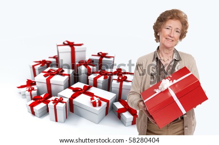 Elegant mature woman holding a present against a background full of gift boxes
