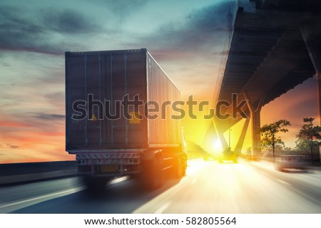Container truck on the highway. Royalty-Free Stock Photo #582805564