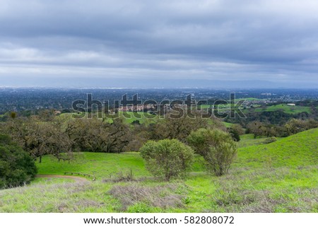 Meadow and hills on a cloudy and rainy day in Rancho San Antonio county park; San Jose and Cupertino in the background, south San Francisco bay, California