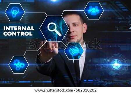 Business, Technology, Internet and network concept. Young businessman working on a virtual blackboard of the future, he sees the inscription: internal control 