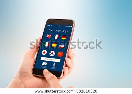 mobile translation application concept.Hand holding mobile phone on blurred abstract backgrounds
